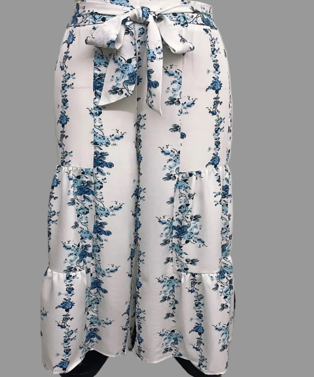 White pants with blue floral pattern on a plain background