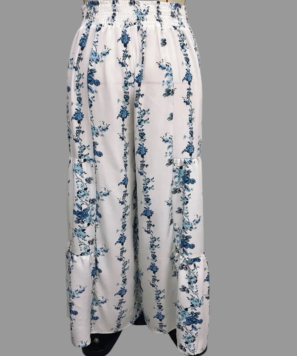 White pants with blue floral pattern on a plain background