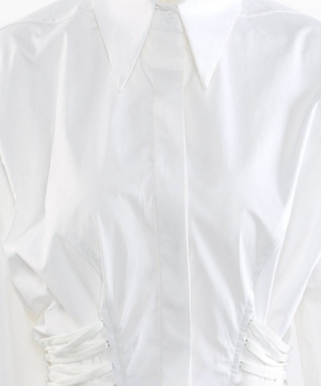 White blouse with ruched details on a white background