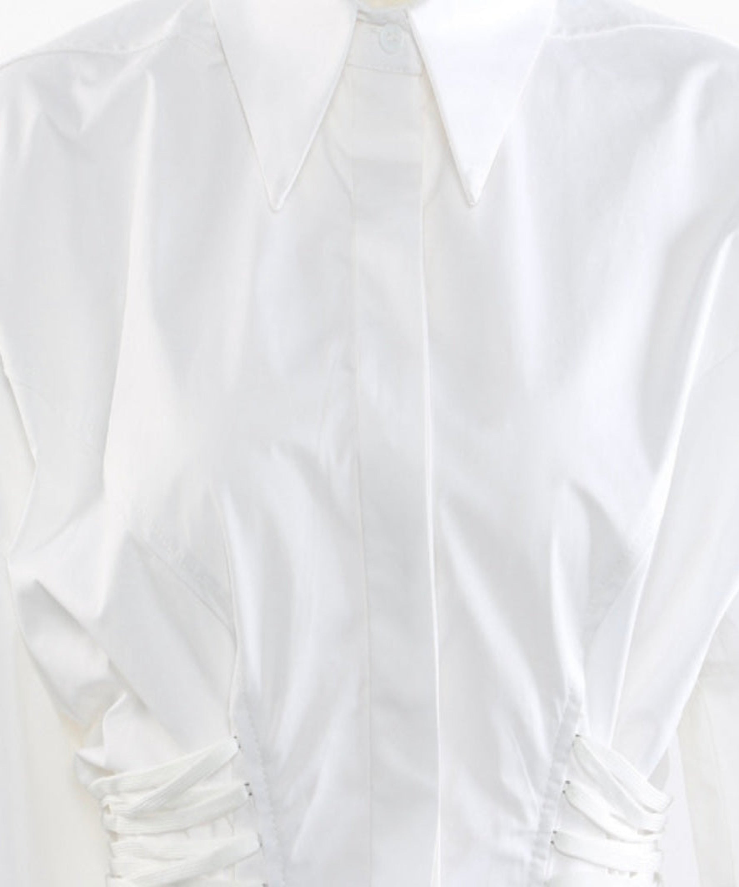 White blouse with ruched details on a white background