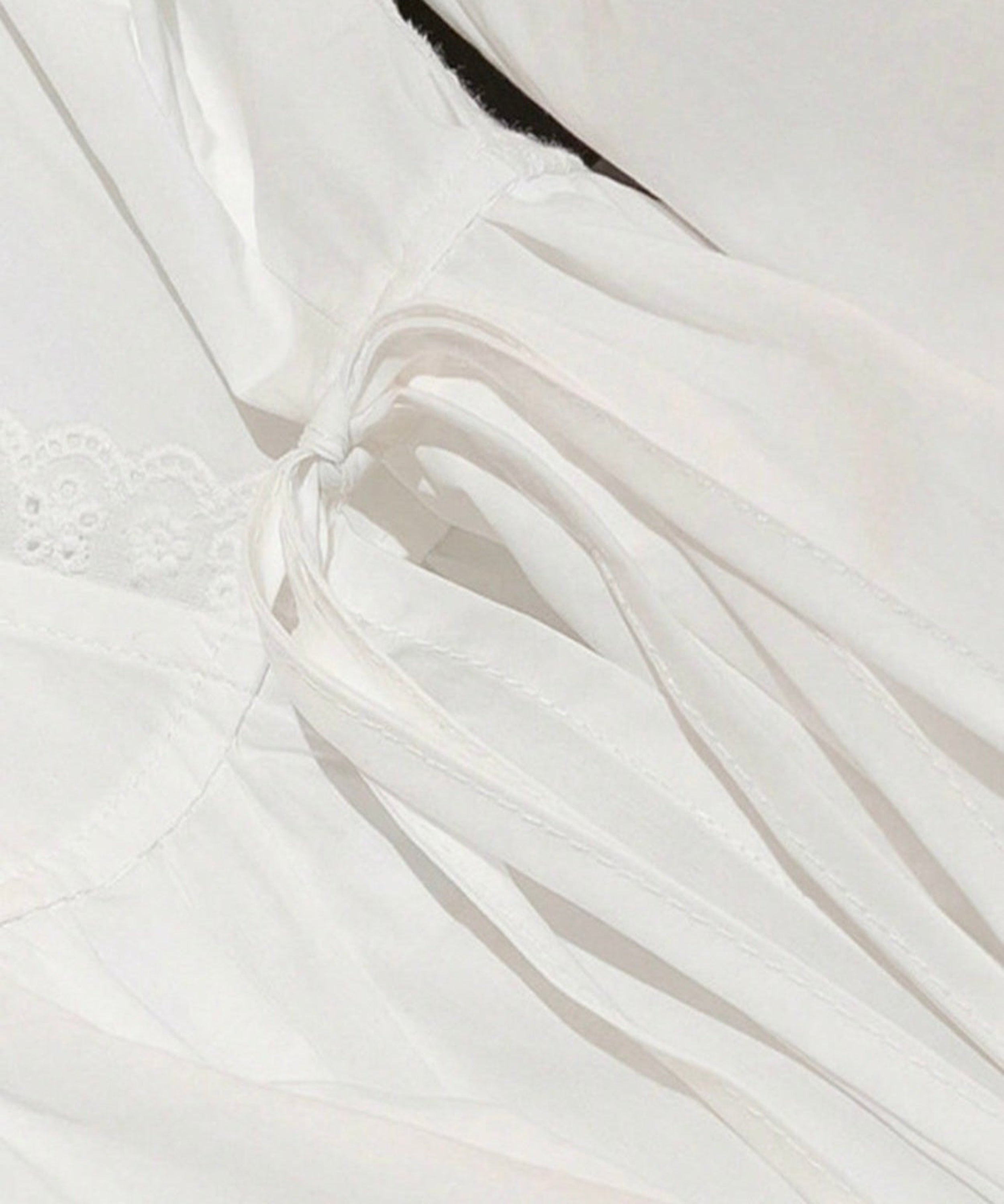Close-up of white fabric with lace trim