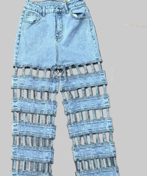 Light blue jeans with a unique cut-out design on a wooden floor.