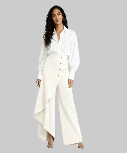 Woman wearing a white blouse and cream-colored skirt on a white background