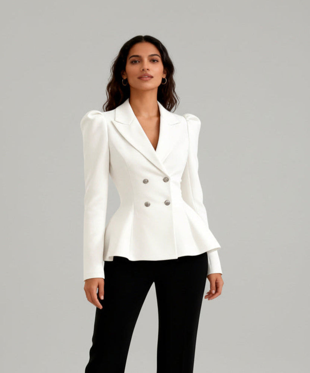 Woman wearing a white blazer and black pants on a white background