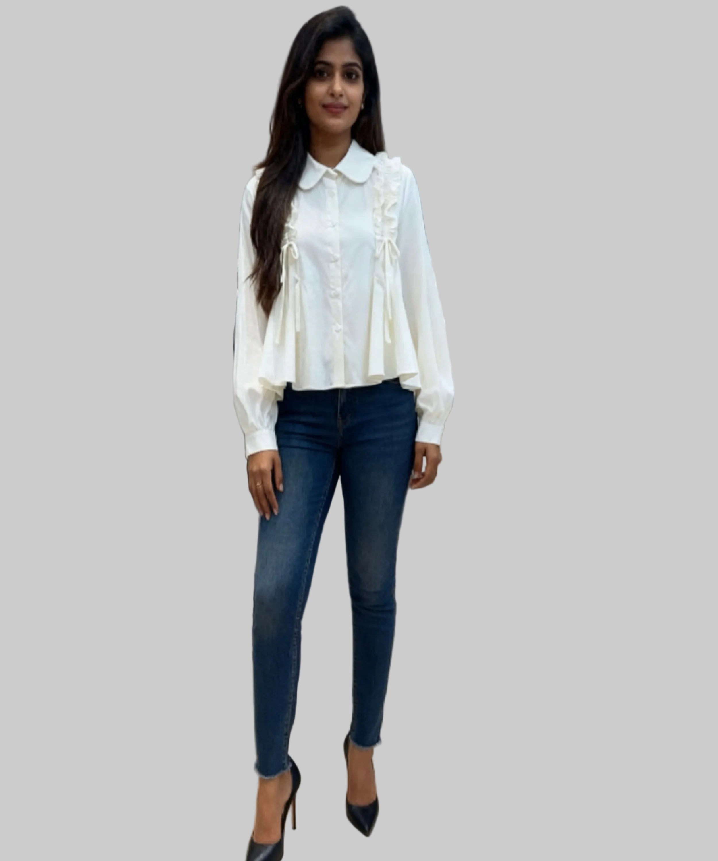 Woman wearing a white blouse and blue jeans standing in a clothing store.