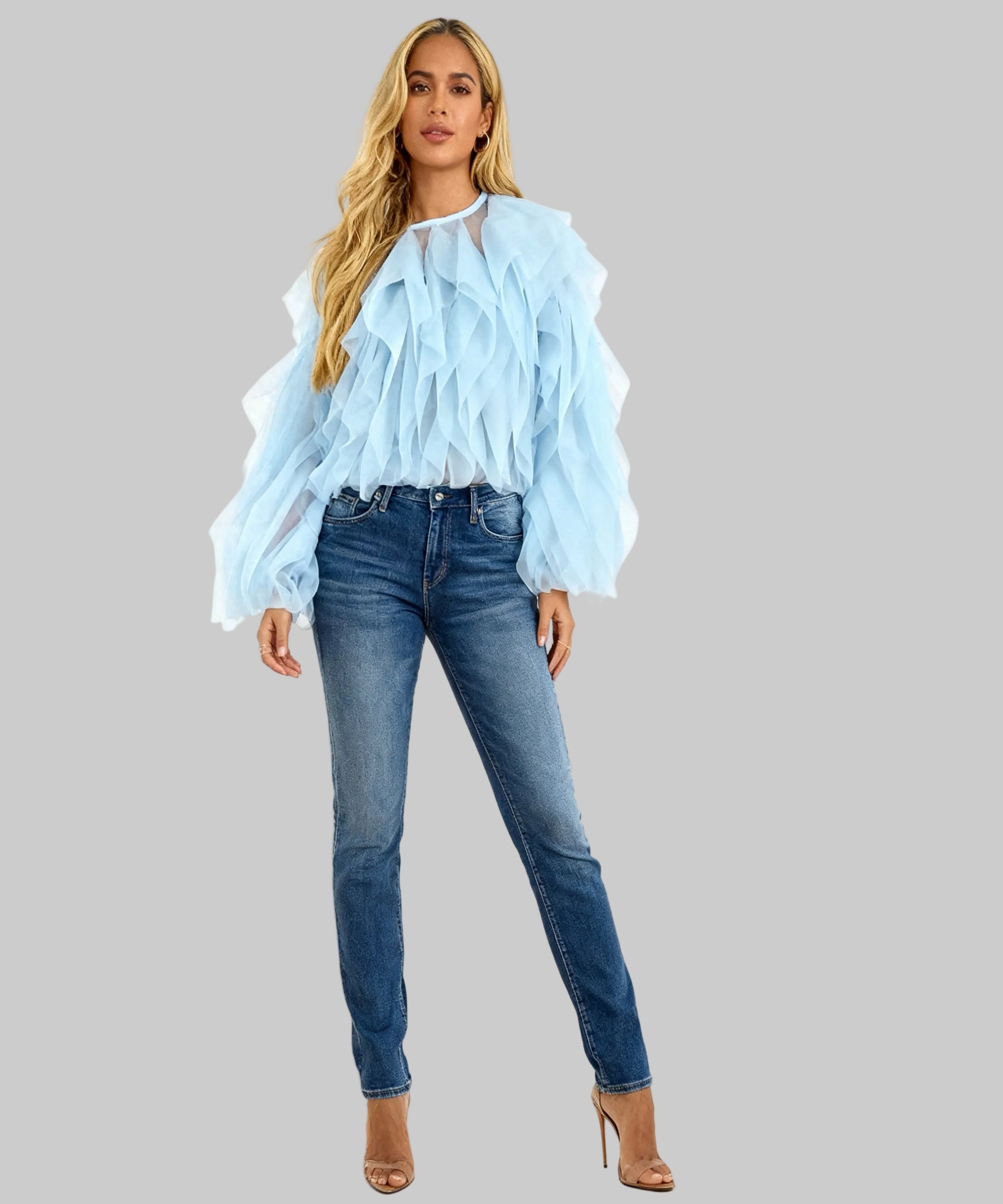 women wearing blue top, jeans and  heels on a white background