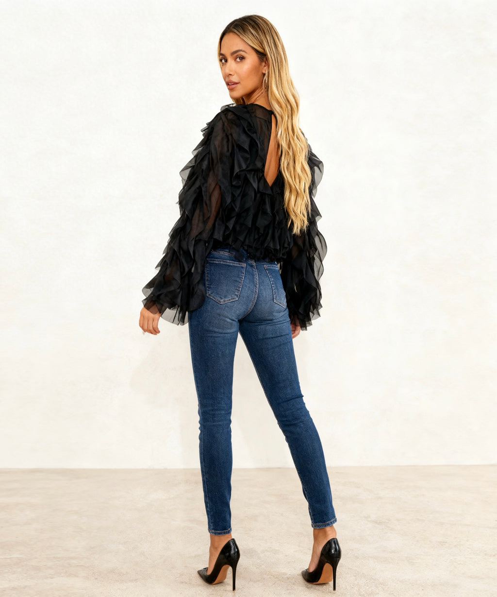 women sitting with the back showing the top