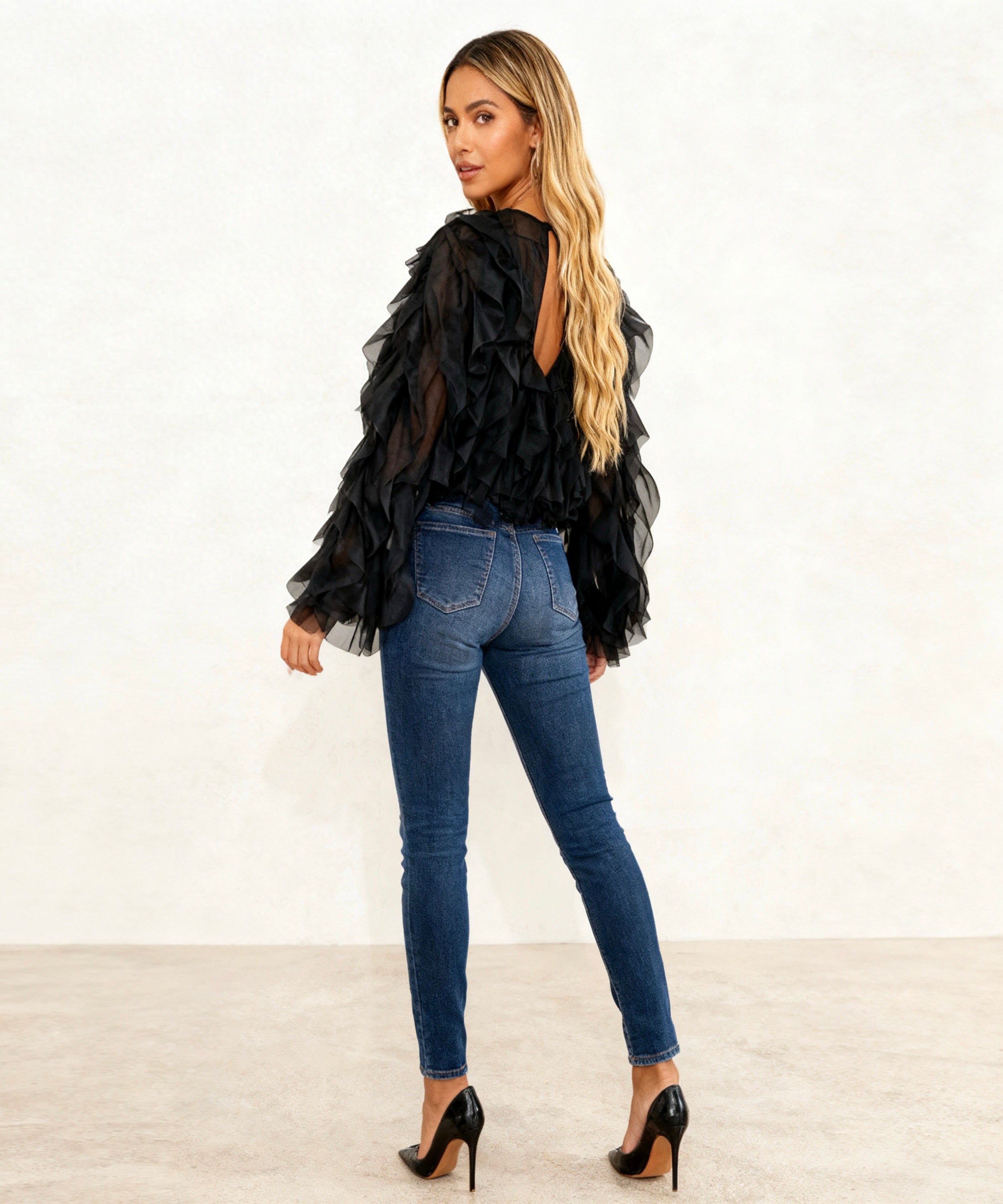 women sitting with the back showing the top