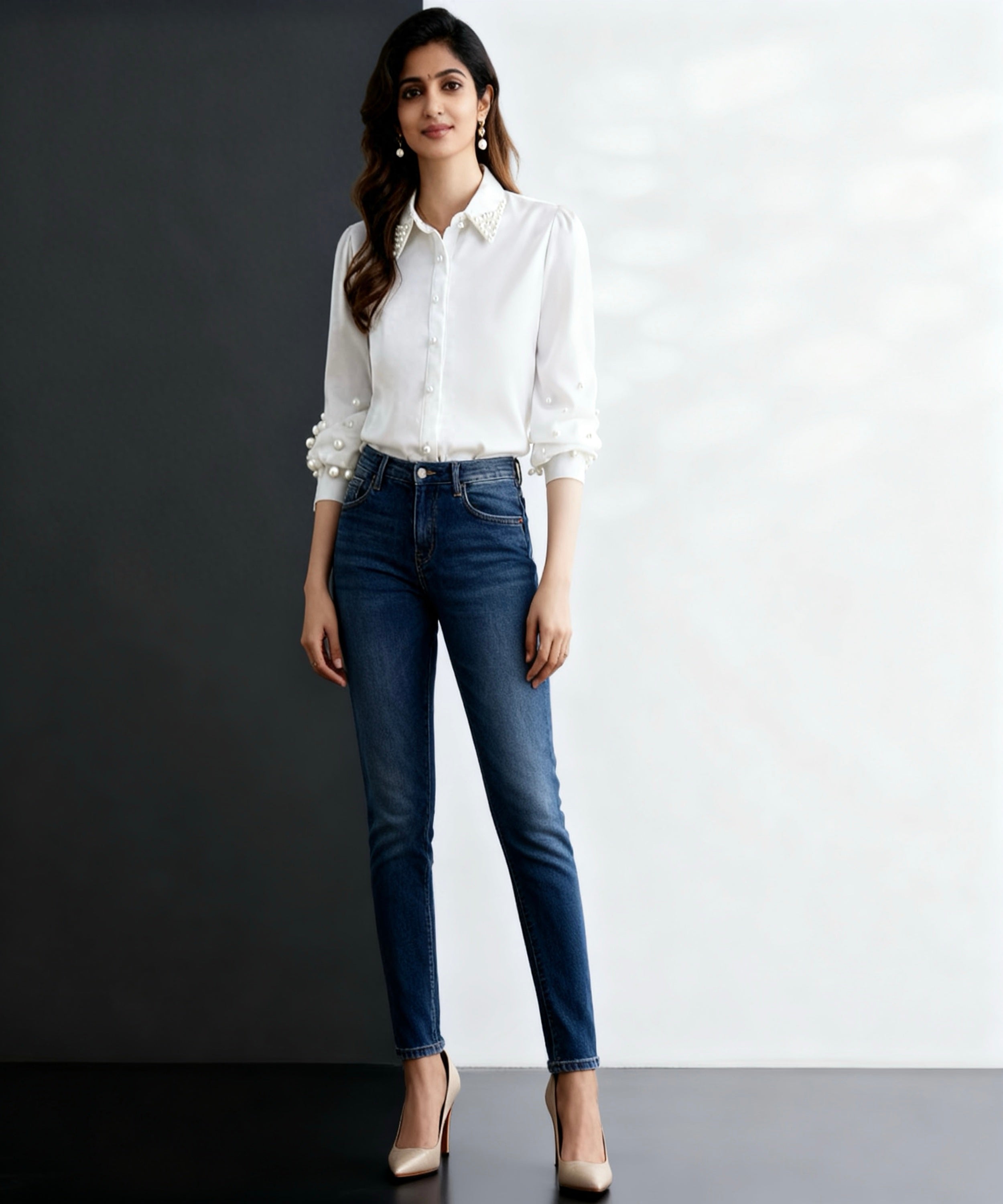 Woman wearing a white shirt and blue jeans against a black and white background