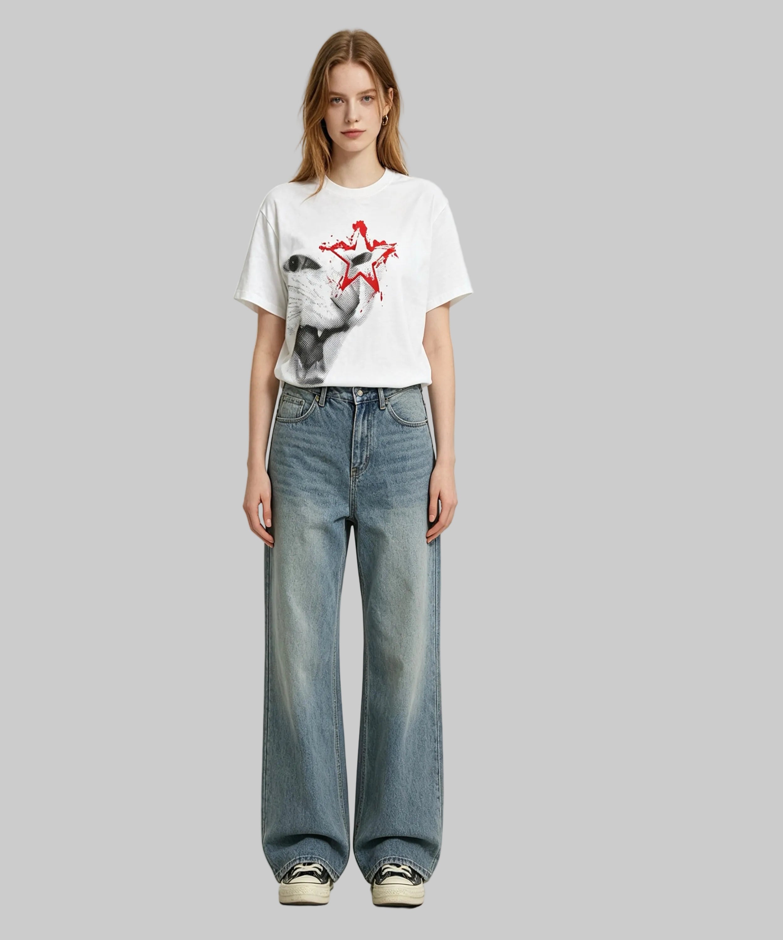 Person wearing a white t-shirt with a graphic design and blue jeans on a white background