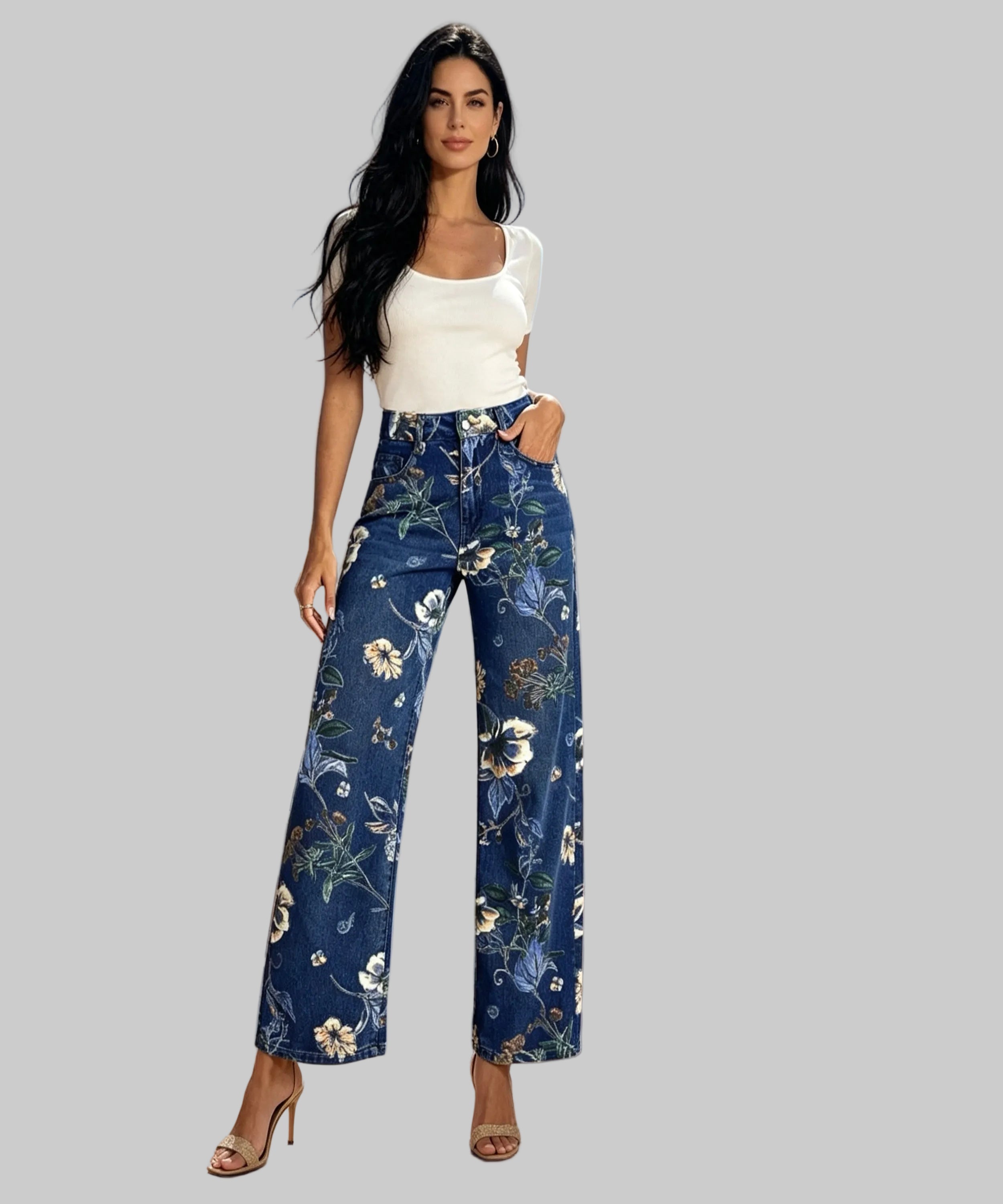Woman wearing blue floral pants and a white top on a balcony.