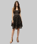 Woman in a leopard print dress standing on white background