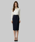 Woman in a professional outfit standing in a white background