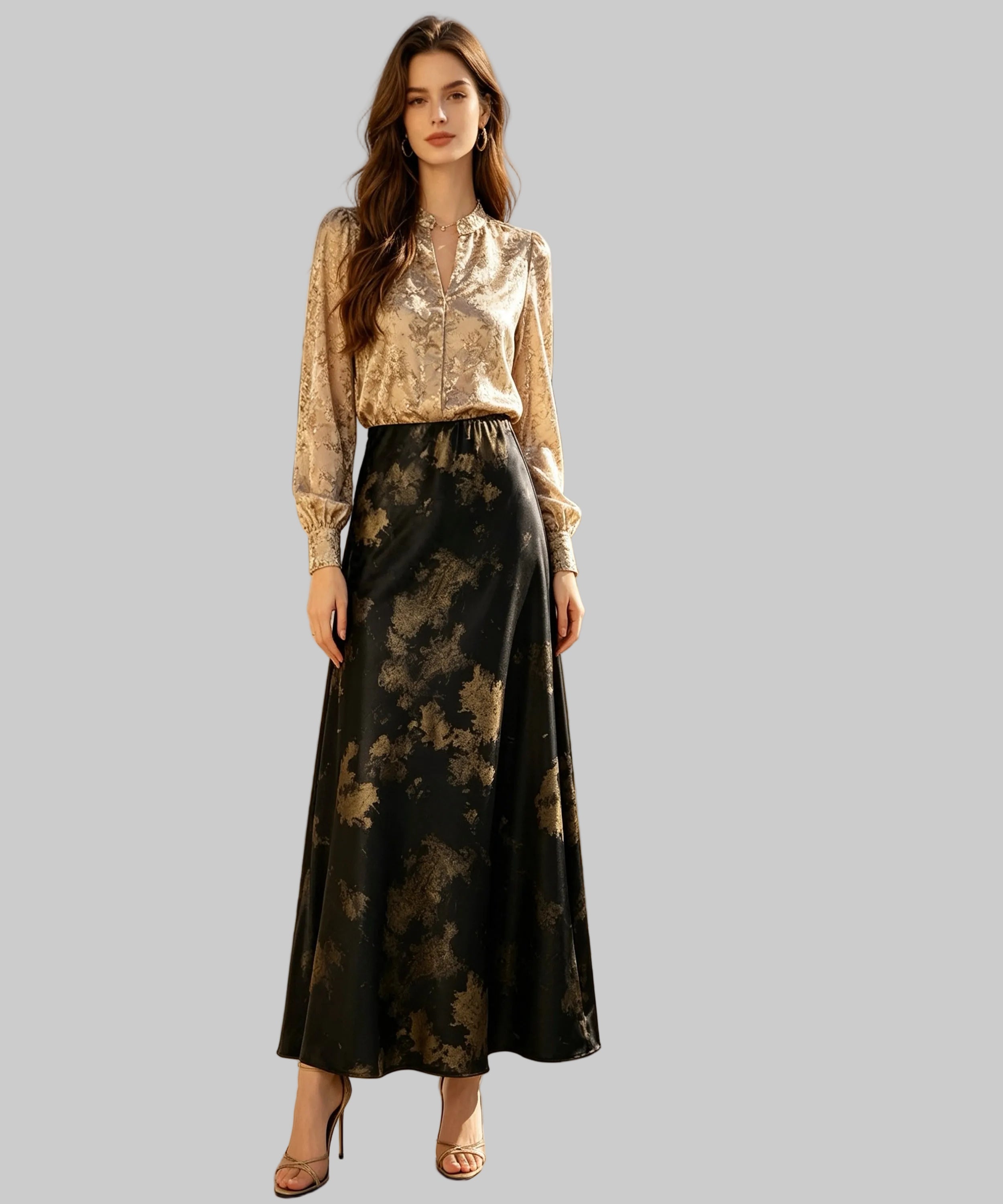 Woman in a gold sequin top and black floral skirt standing on a white background