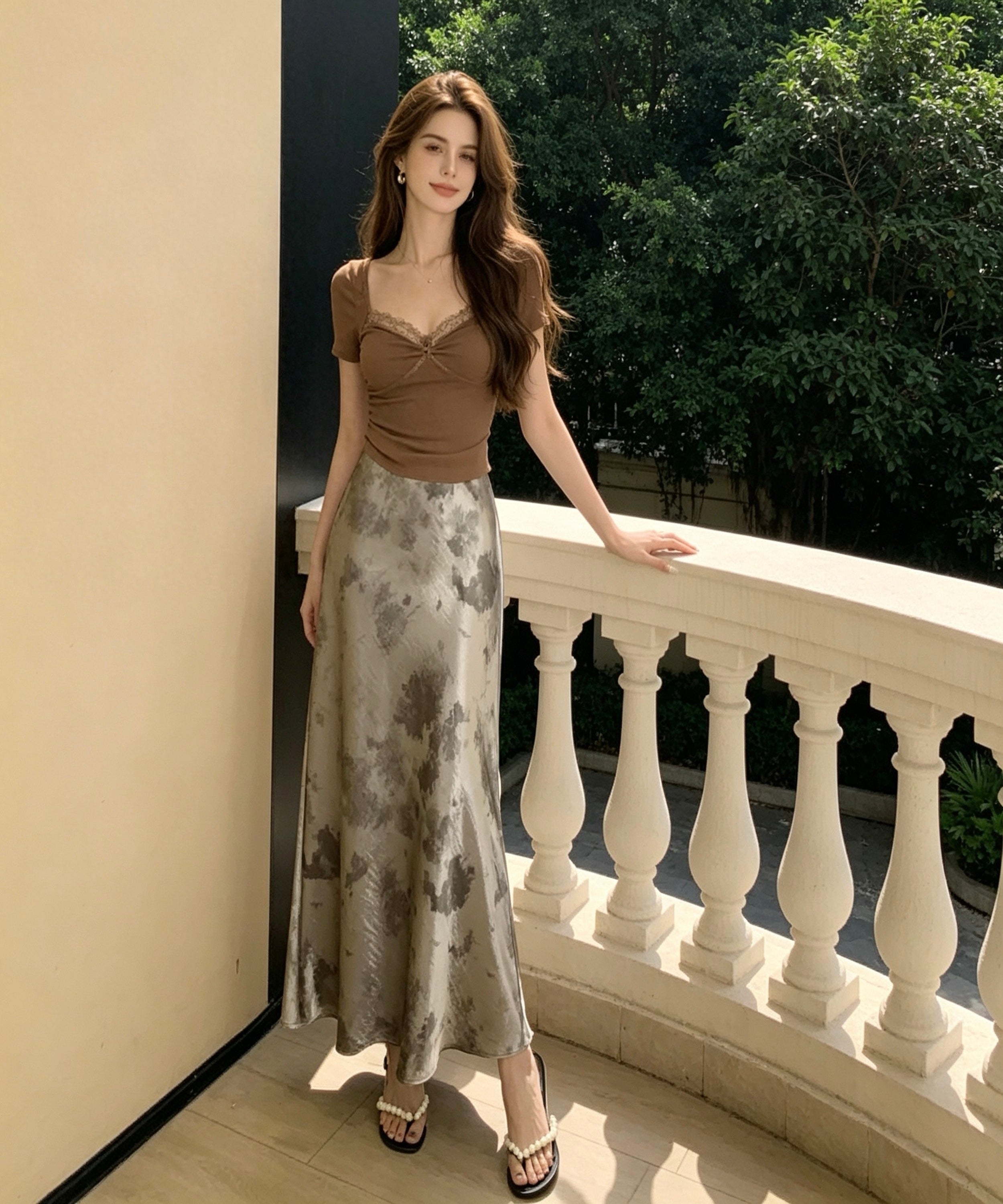 women wearing a long skirt and brown top sitting on a balcony background