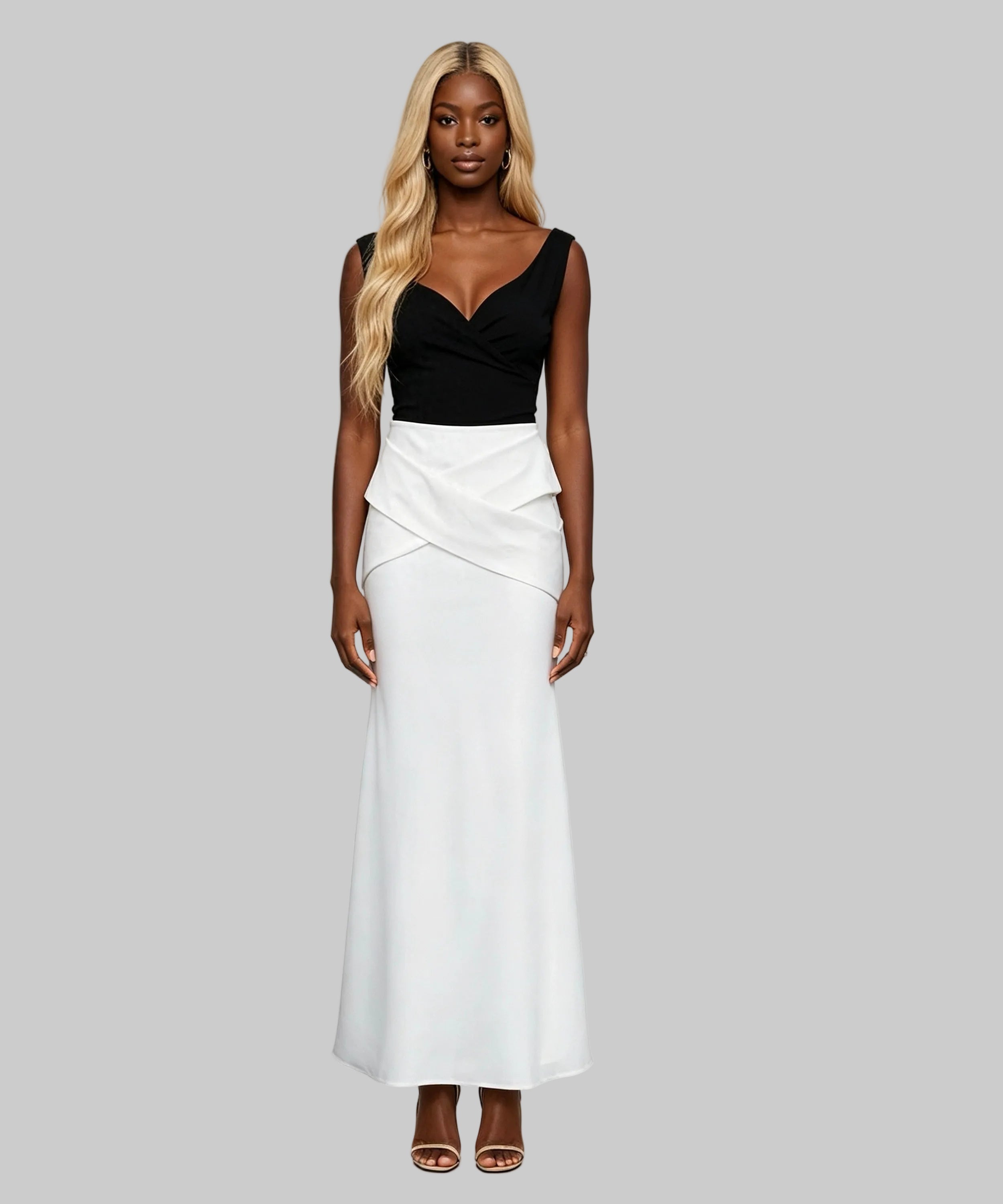 African women dressed with black top and white skirt sits on a white background
