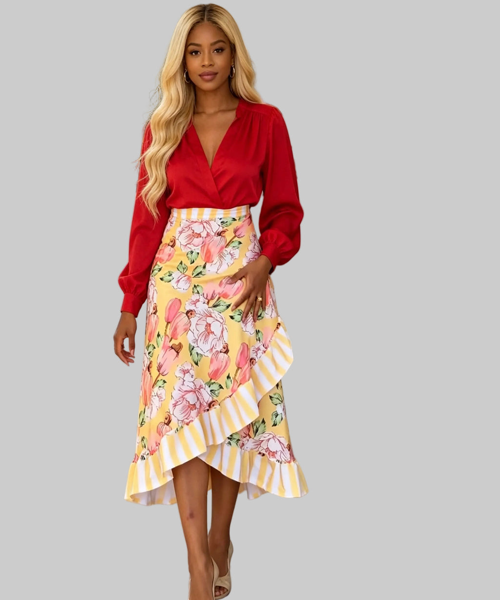 Woman wearing a red blouse and yellow floral skirt standing on a white background