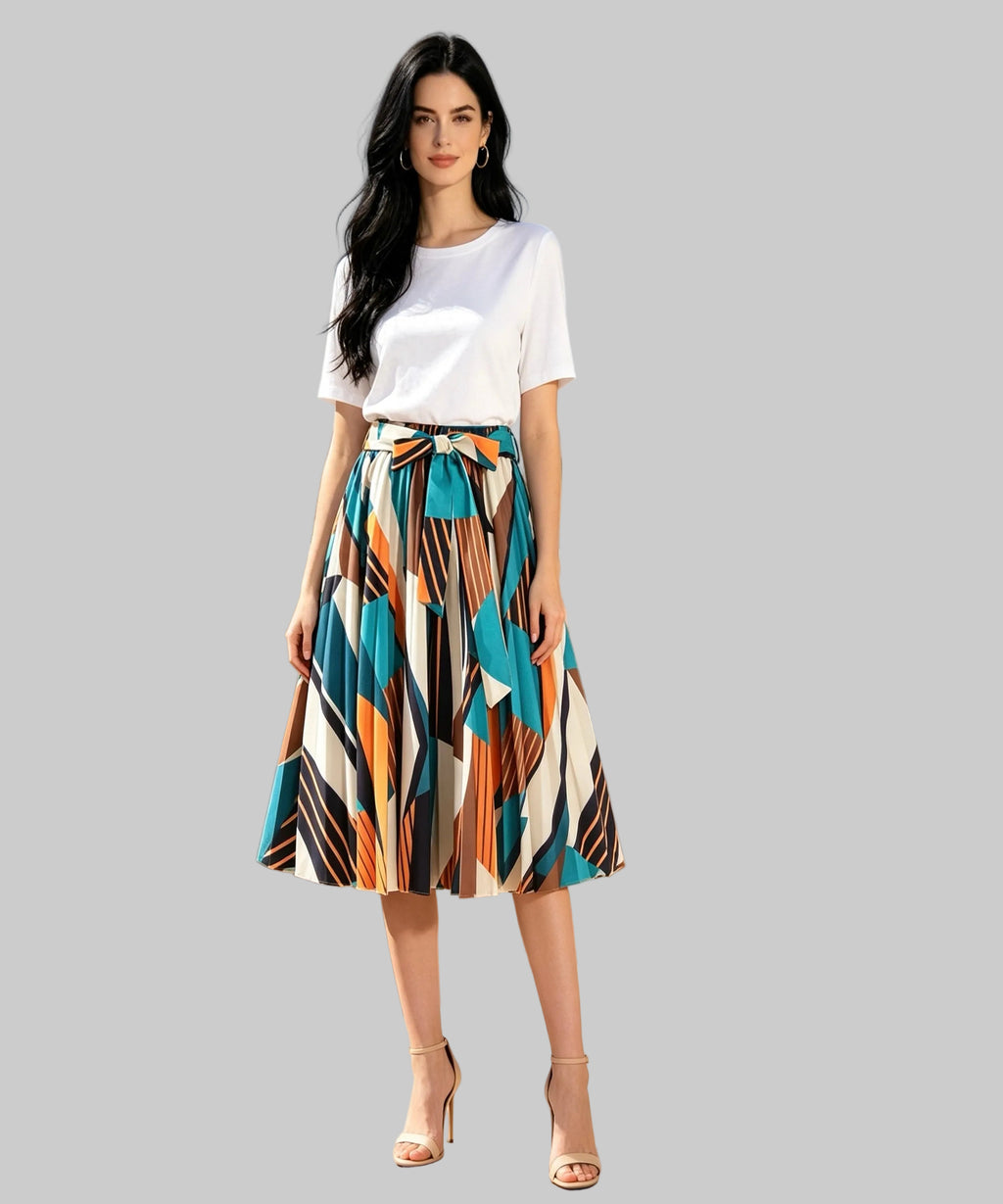 Woman in a colorful skirt and white top standing on a white background