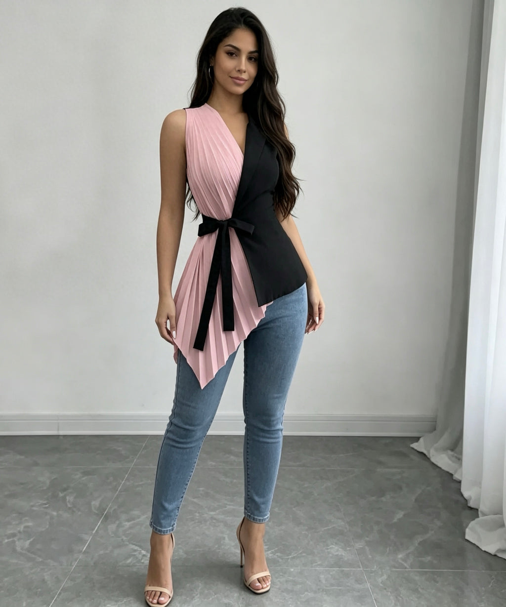 Woman wearing a black and pink top with blue jeans in a minimalistic setting