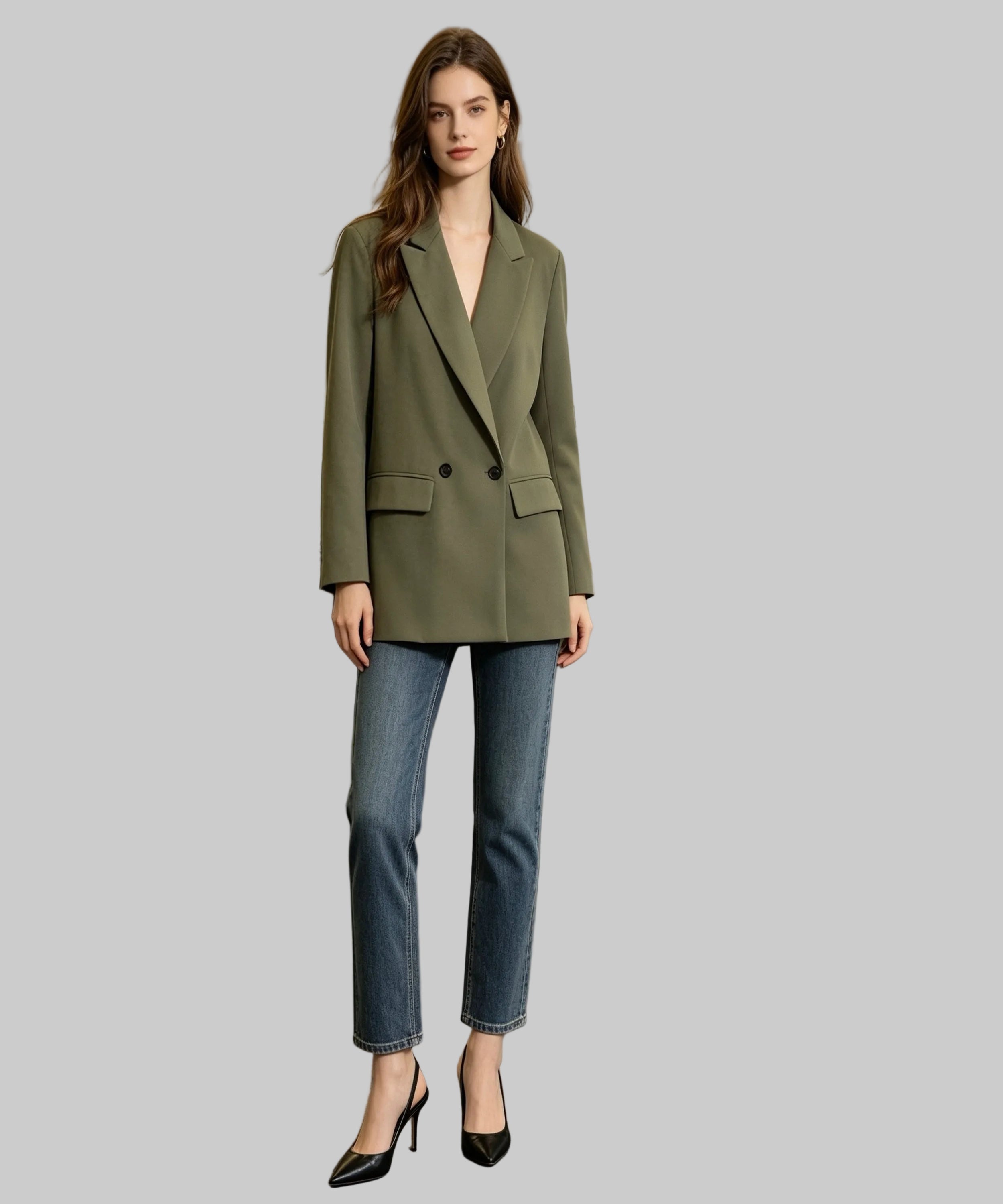 Woman in a green blazer and blue jeans standing in an office setting