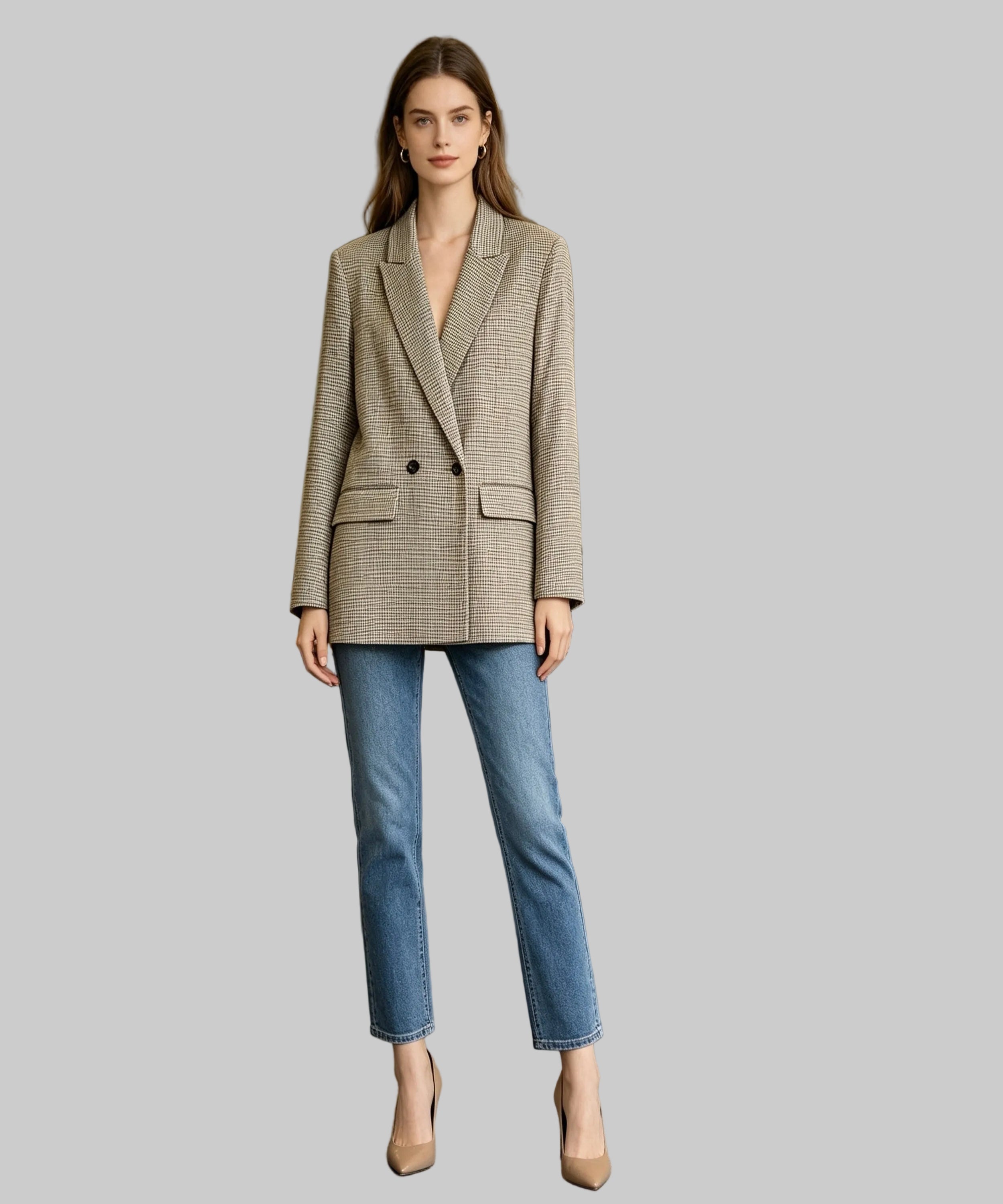 Woman wearing a blazer and jeans in an office setting