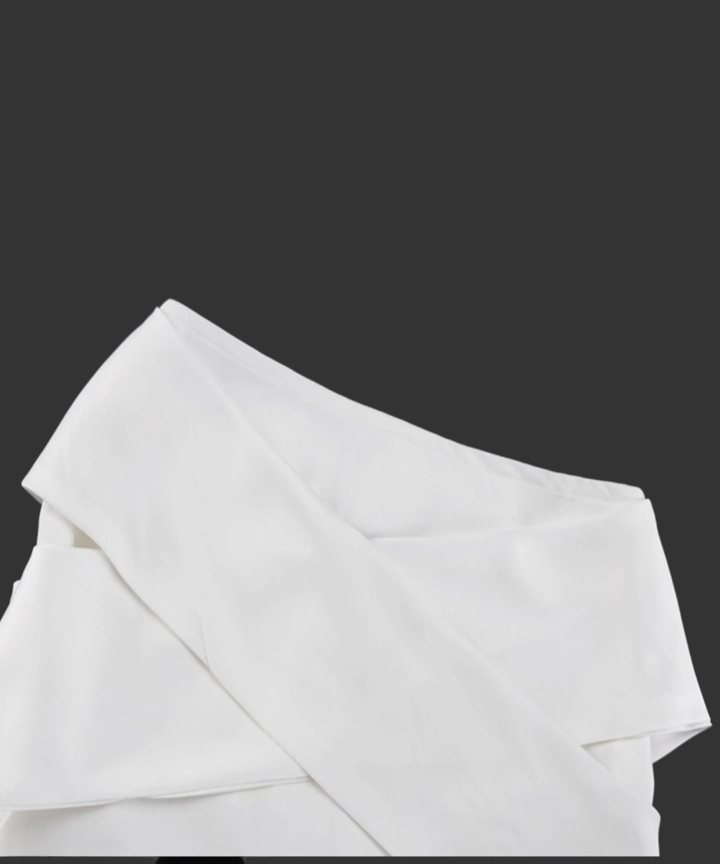 White fabric draped over a black background