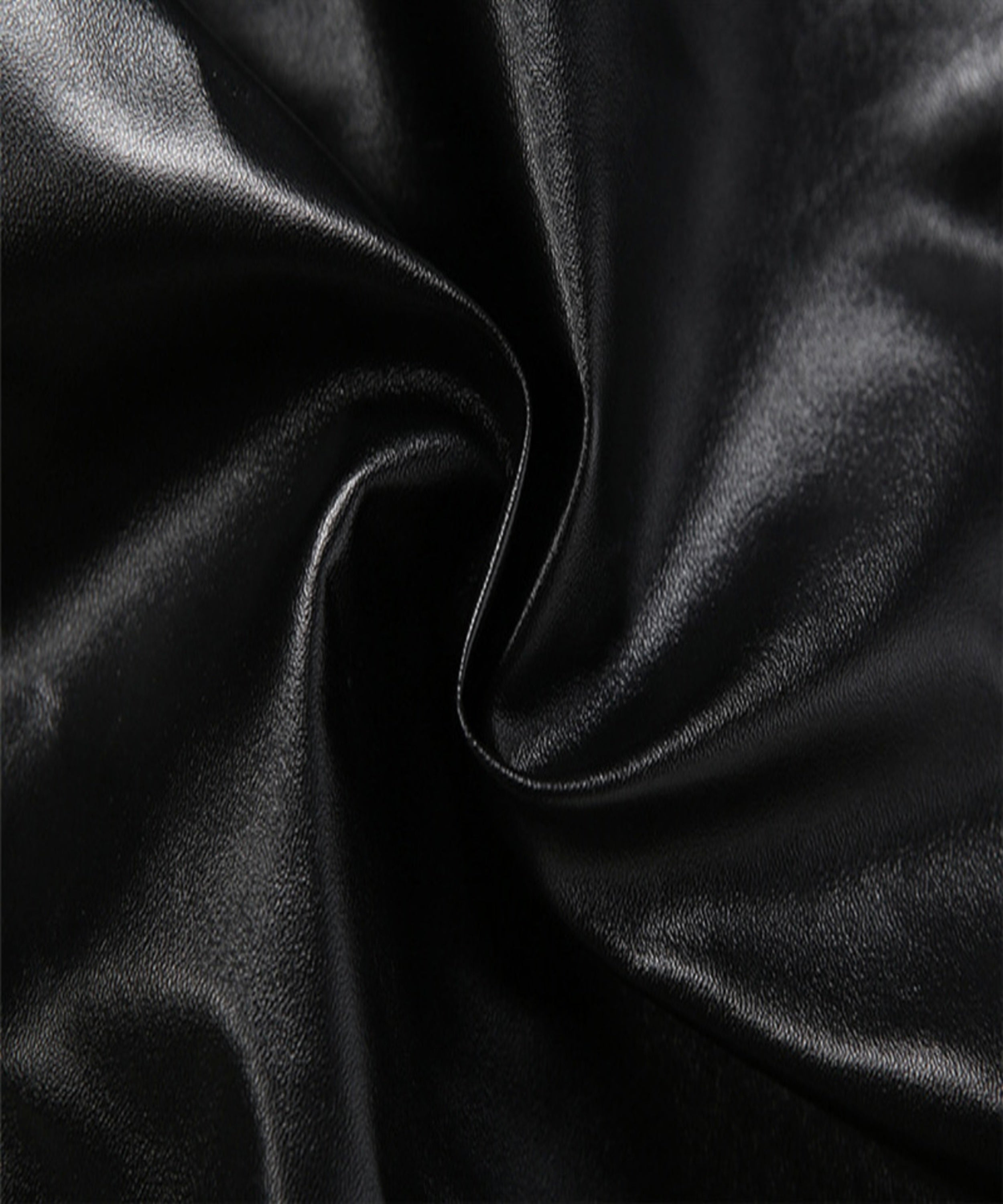 Close-up of black satin fabric with folds