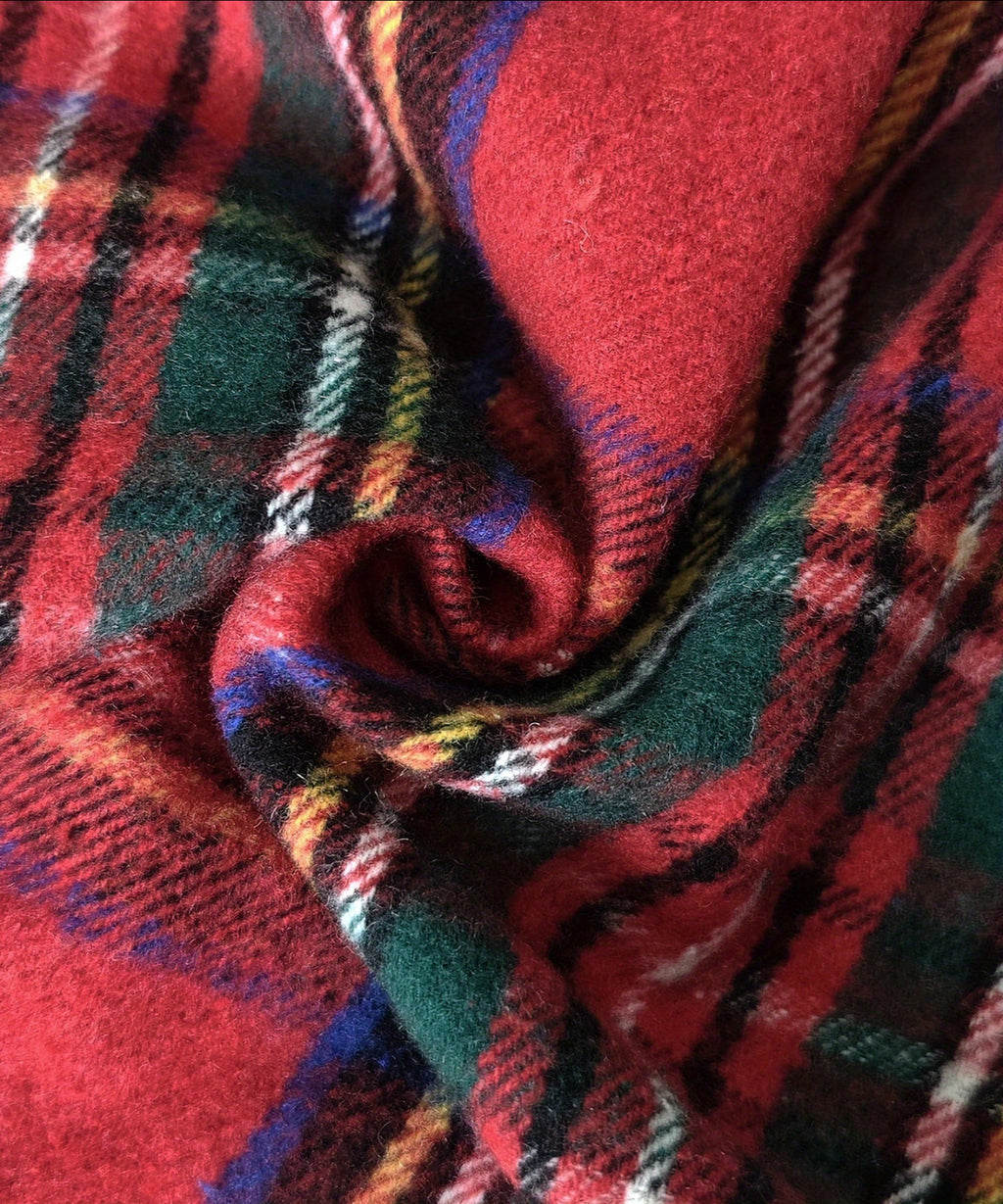 Close-up of plaid fabric with red, green, and blue colors.
