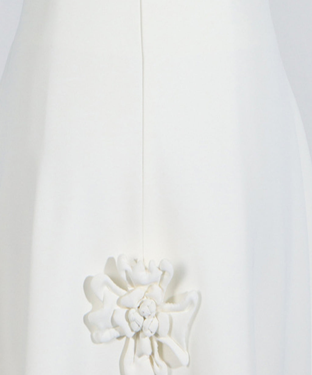 White floral brooch on a white background