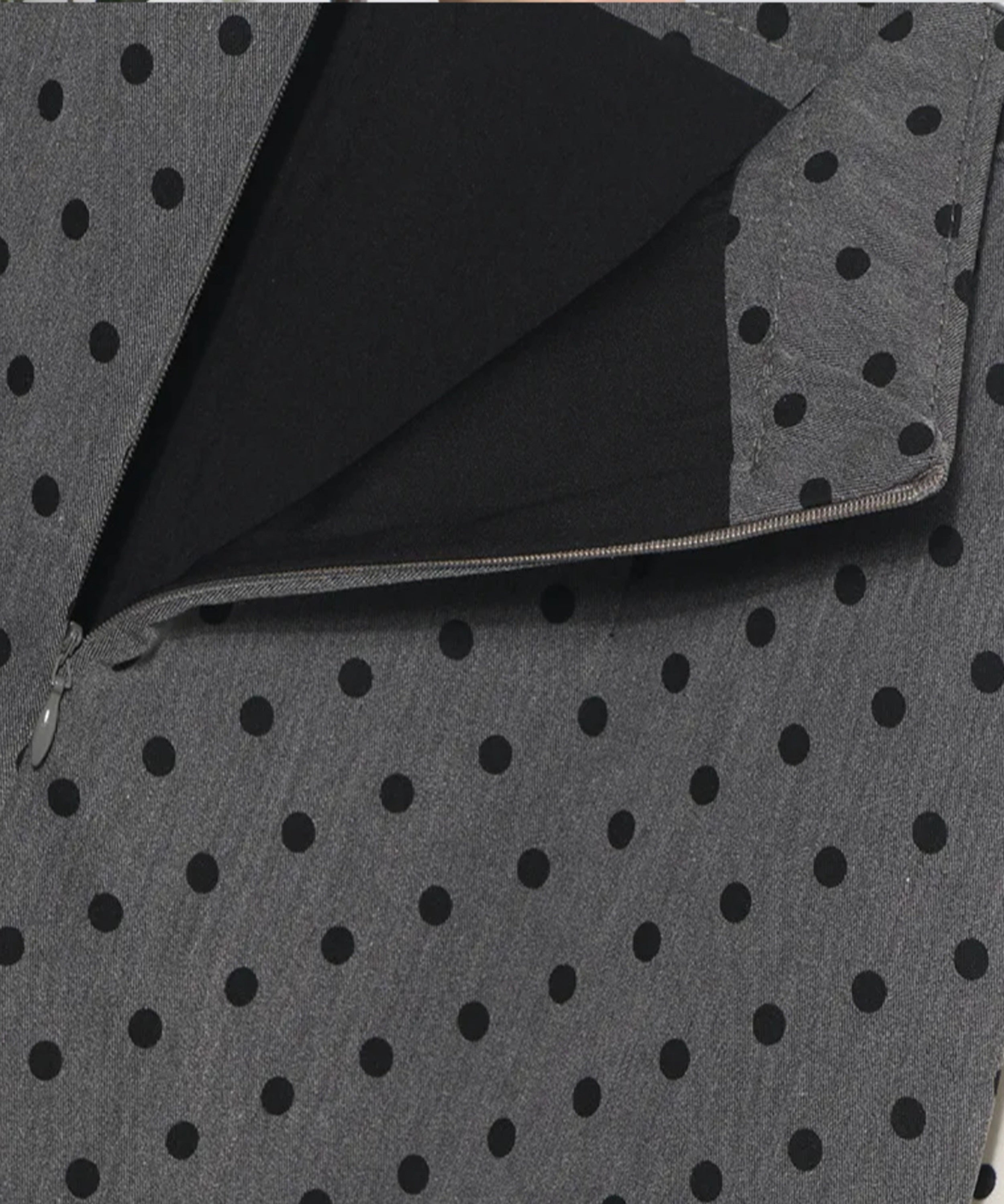 Gray fabric with black polka dots and a zipper
