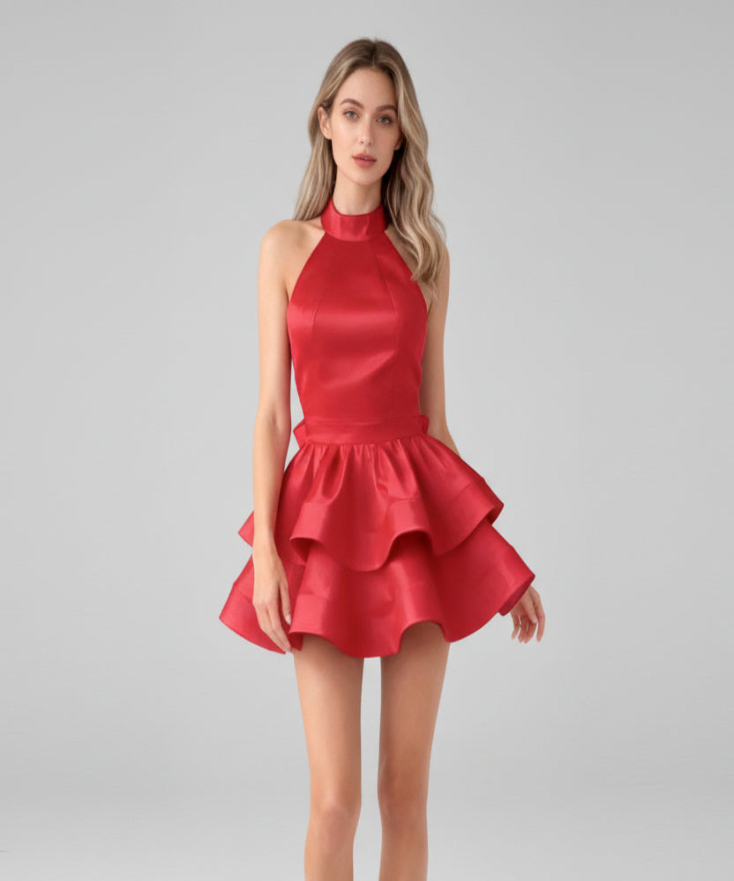 Red dress worn by a model on a light grey background