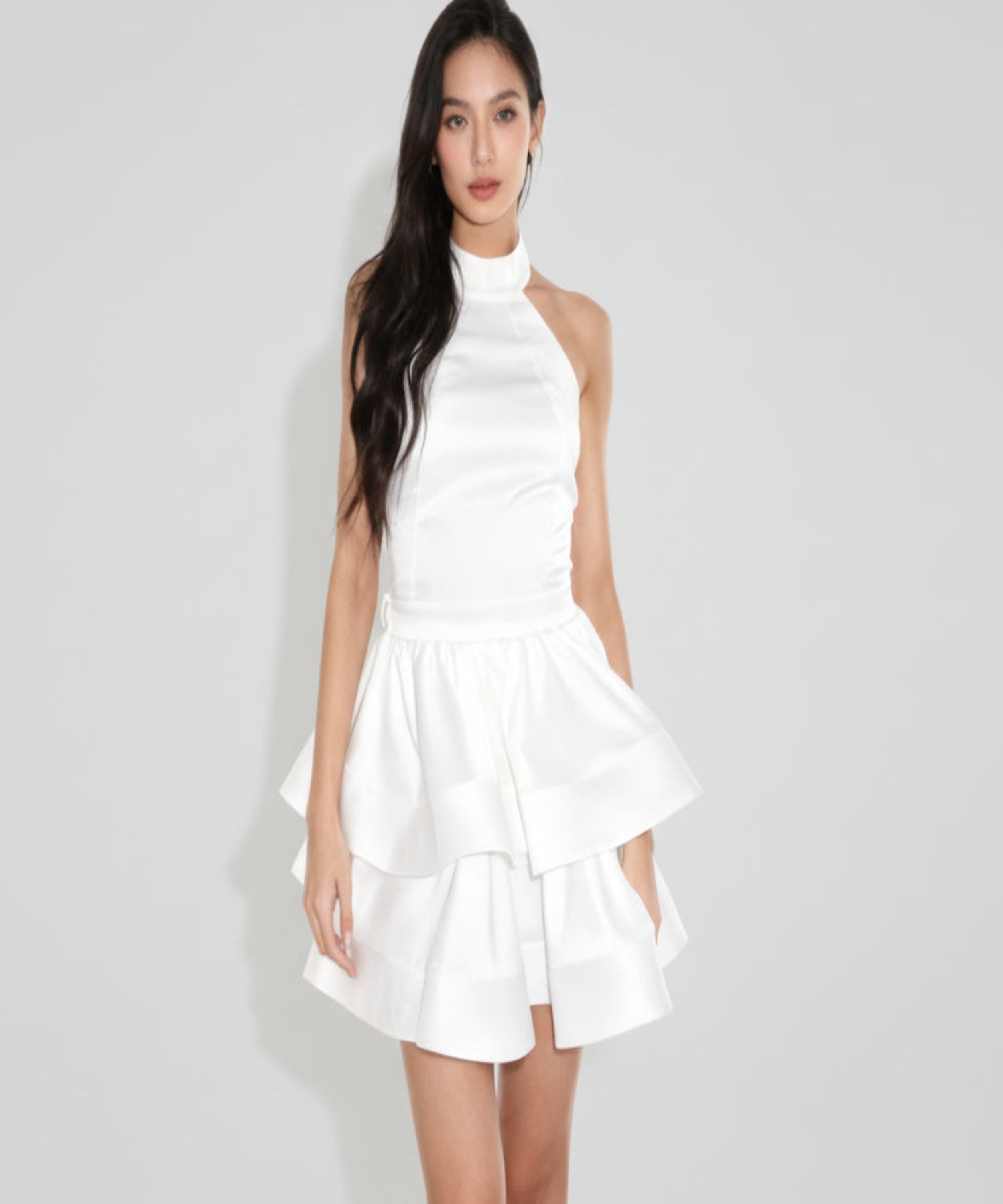 Woman wearing a white dress on a white background