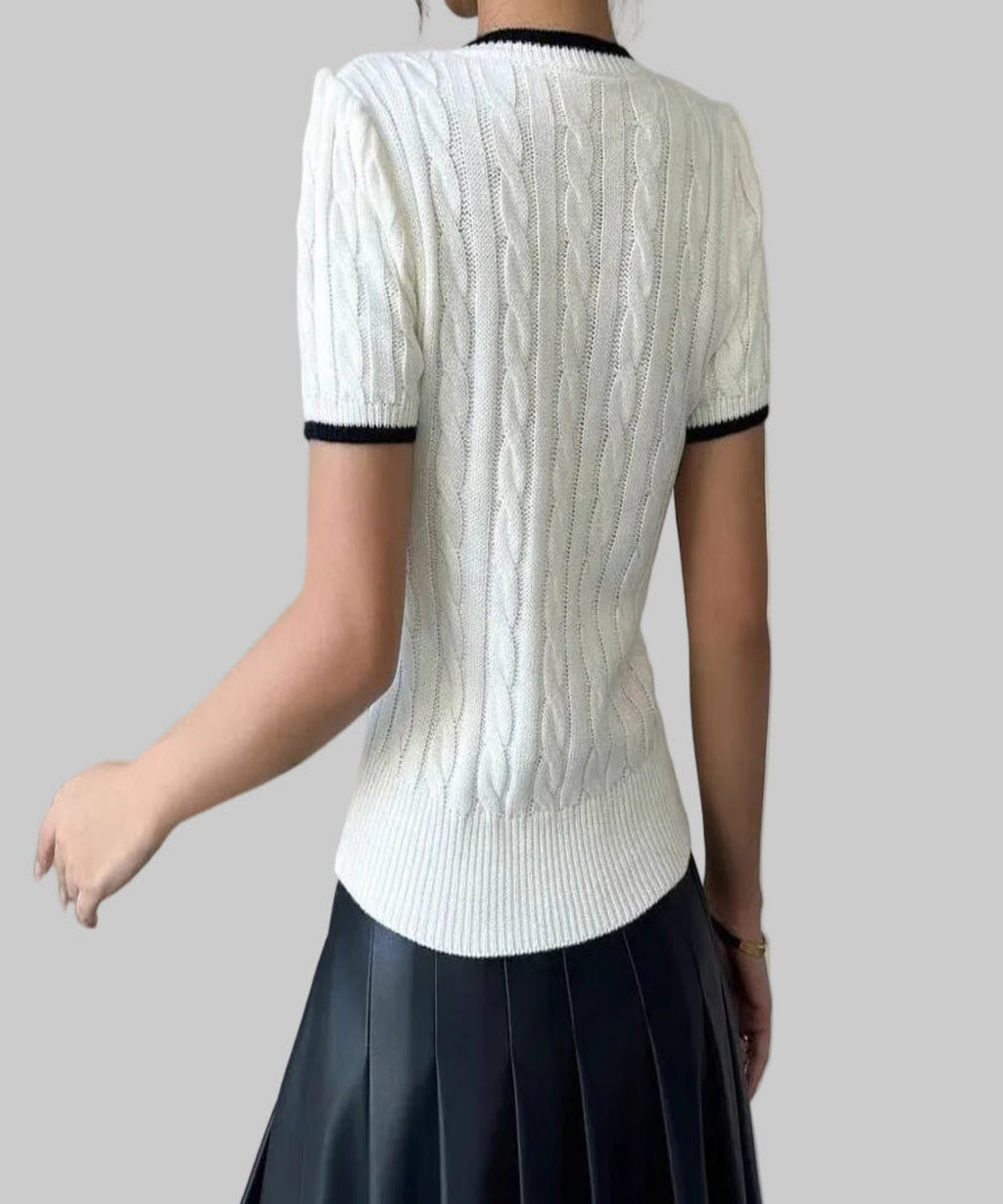 women sits with the back on a white top in a white background
