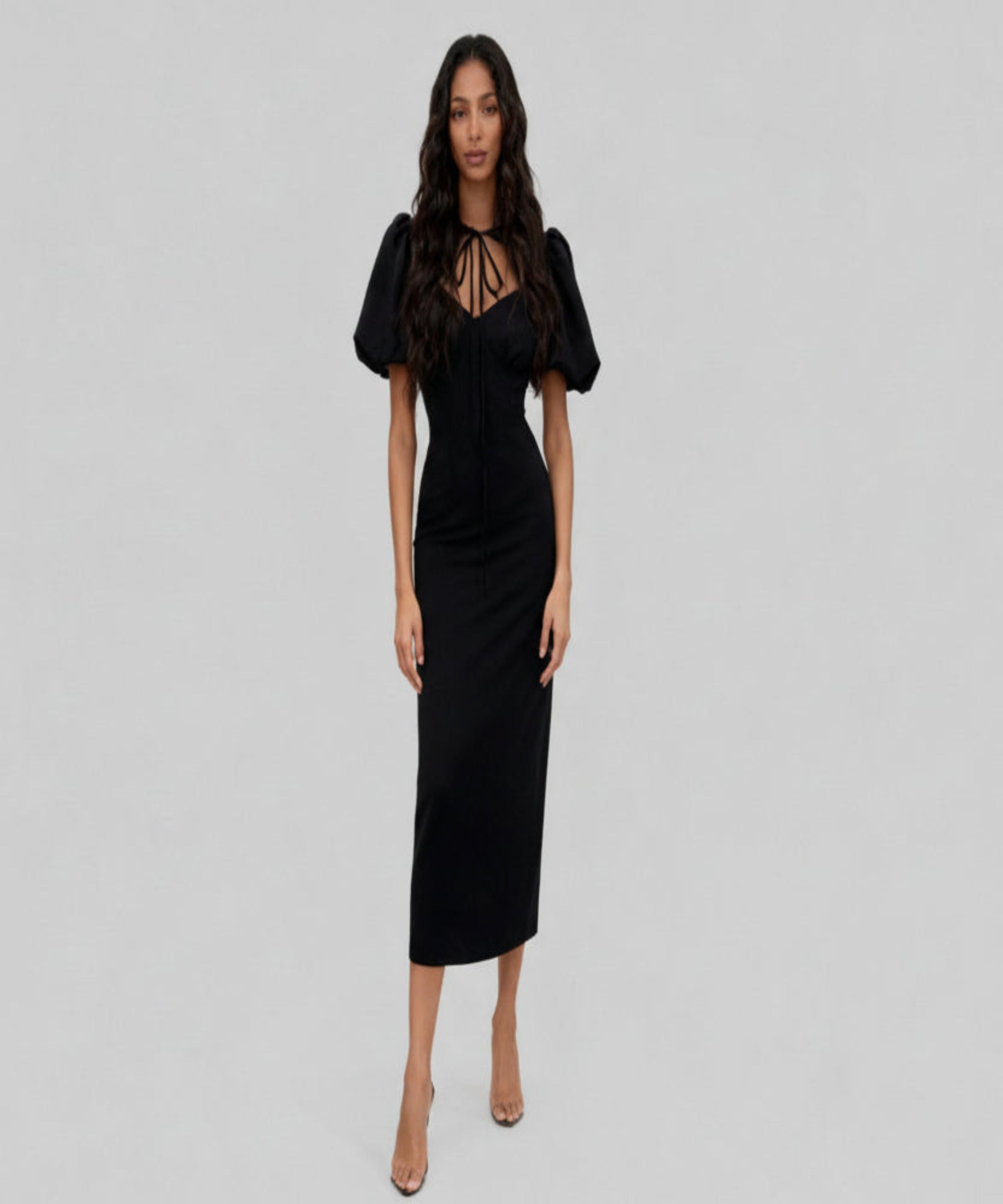 Woman wearing a black dress on a white background