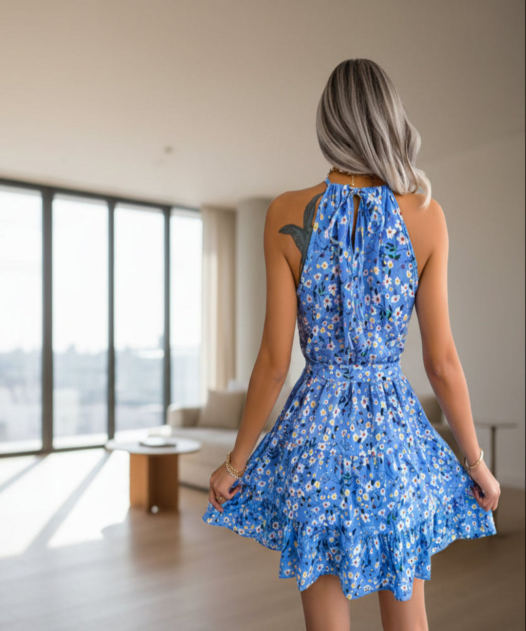 Woman wearing a blue floral dress in a living room background