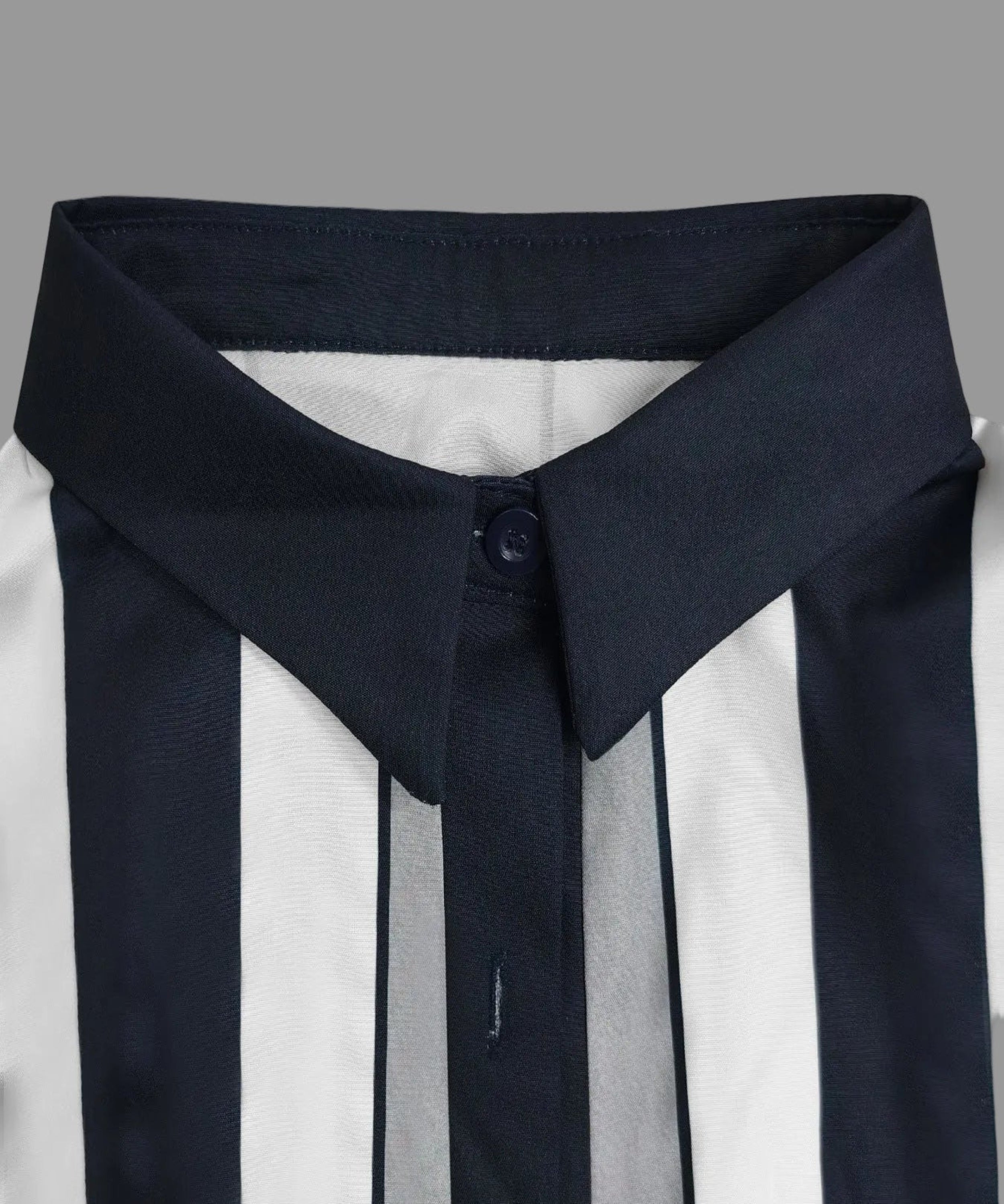 Close-up of a navy blue and white striped shirt with a high collar on a light gray background