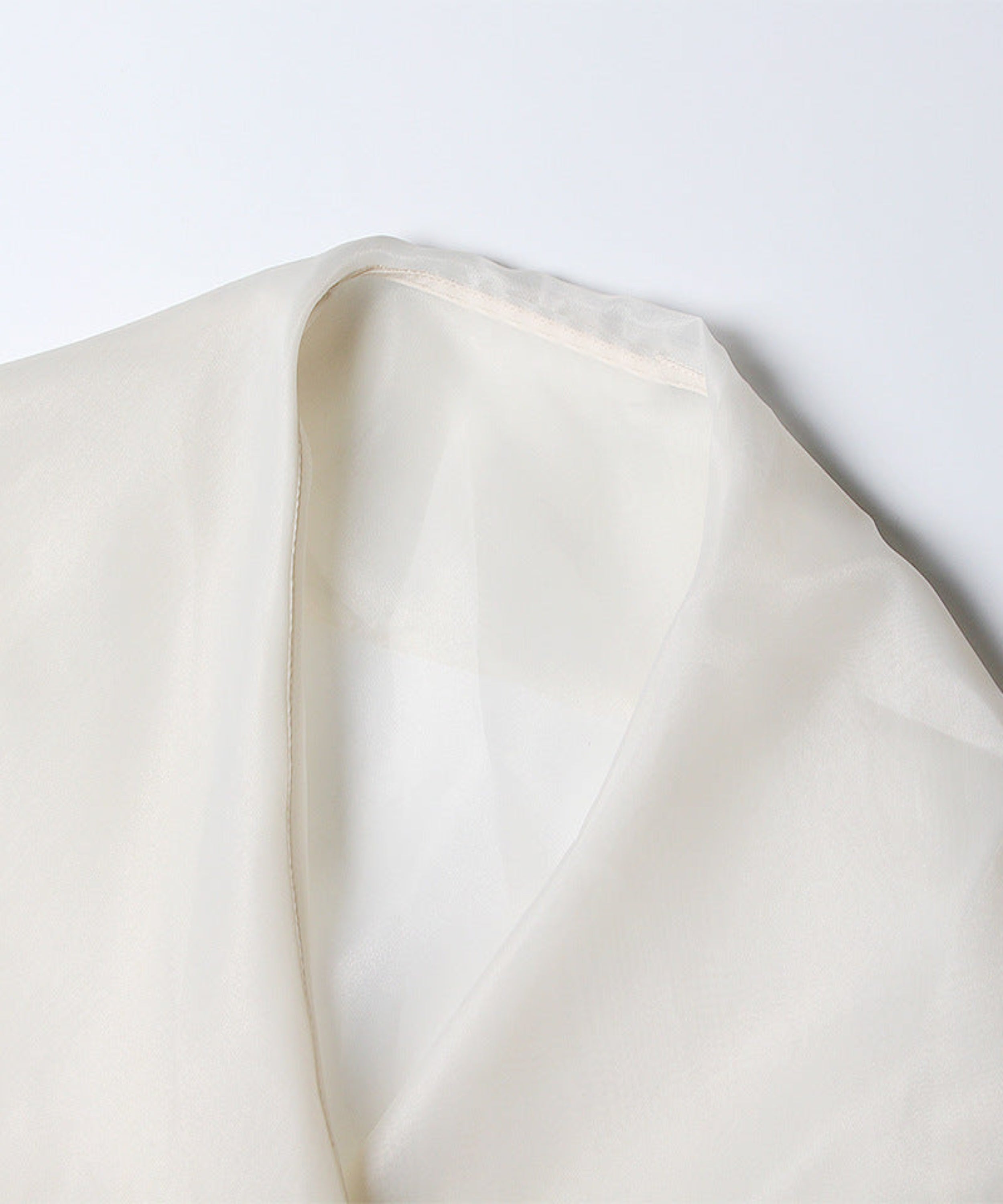 Close-up of a beige fabric texture on a white background